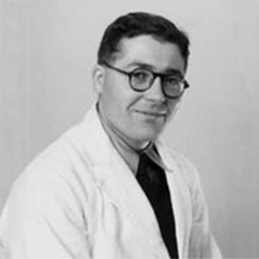 Smiling male doctor in a white lab coat and glasses, posing against a plain background, illustrating a professional medical context.