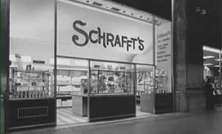 Schrafft's storefront showcasing its iconic signage and display of candies and snacks, highlighting a classic retail experience.